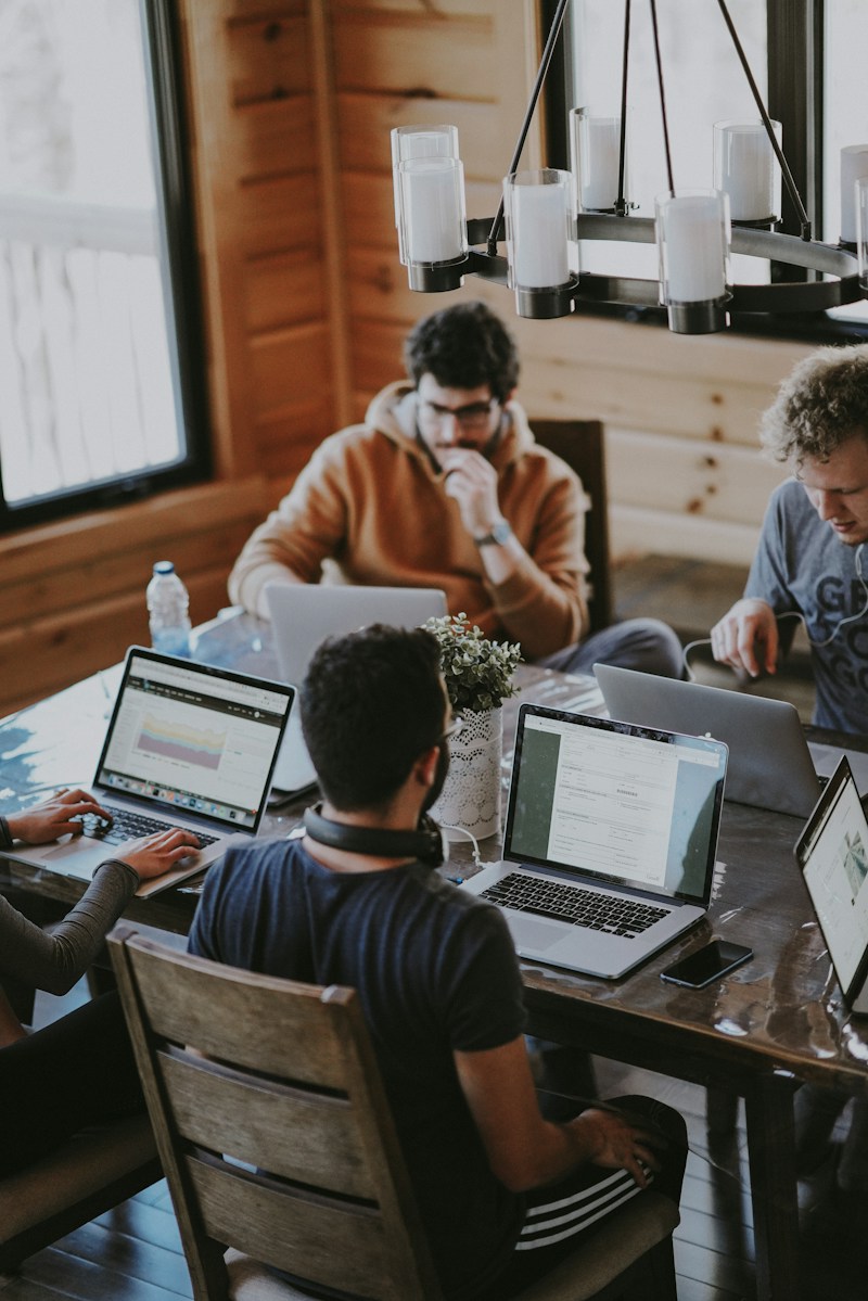 Colleagues collaborating around a shared workspace